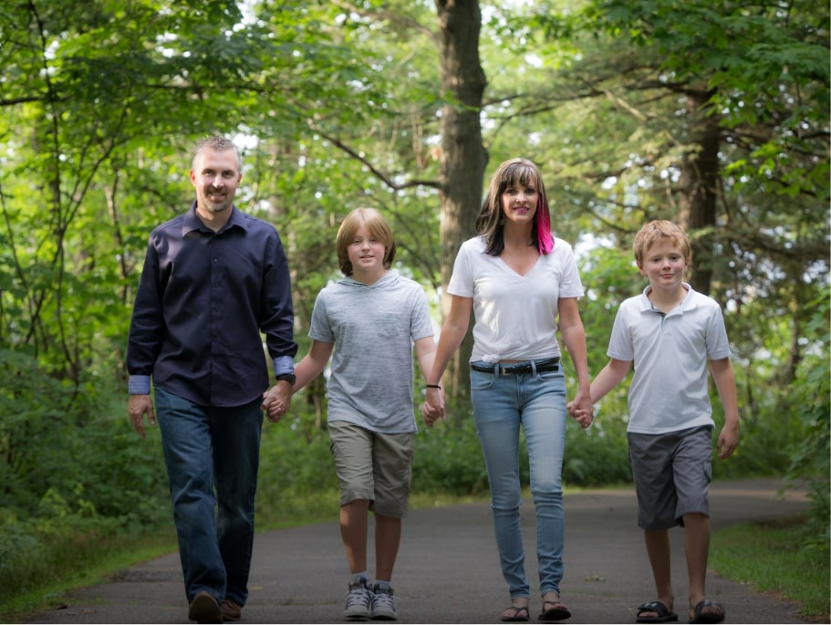 Family portrait walking with woods in background