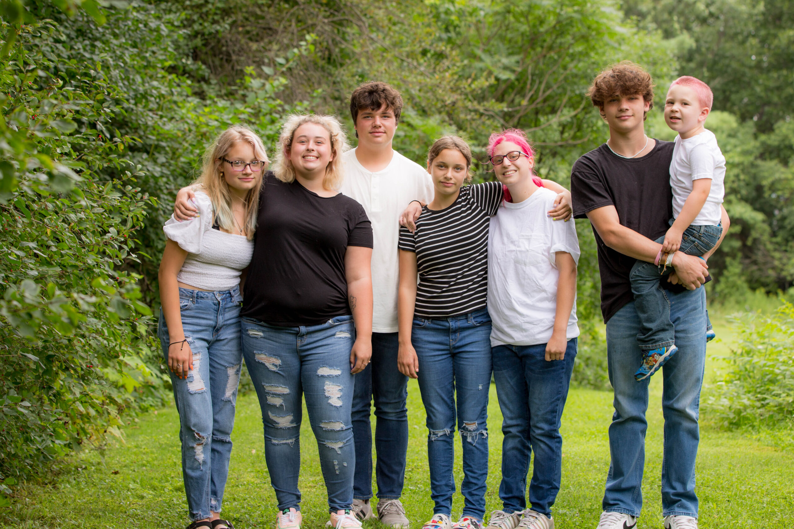 A family standing next to each other outside.